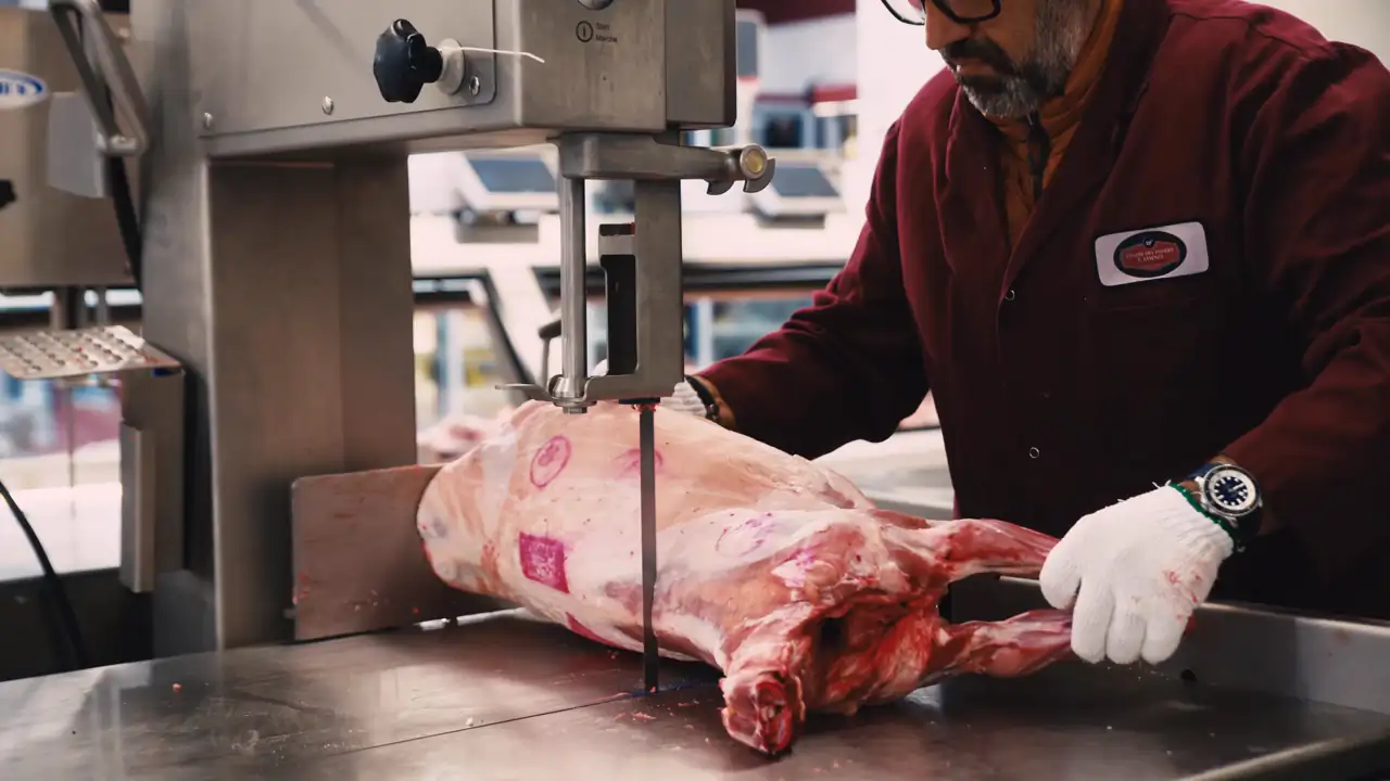 Butchers at work behind the counter at Centre des Viandes F. Iasenza.