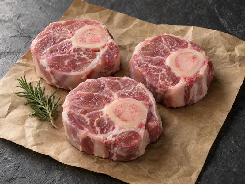 Three raw slices of pork osso buco
