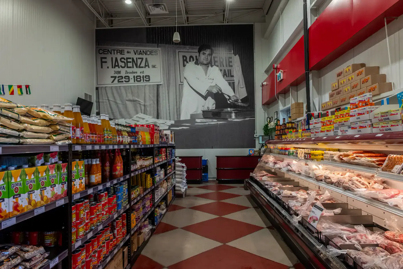 Aisles of the Dollard-des-Ormeaux store, with a large archival photo of the butcher shop on the wall