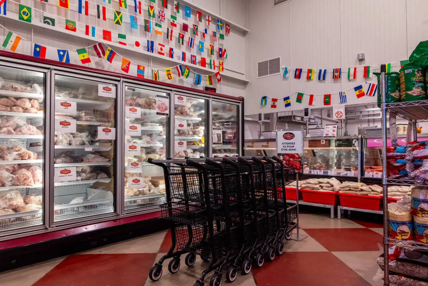 Glass-door freezers, shopping carts and world flags at the Dollard-des-Ormeaux store