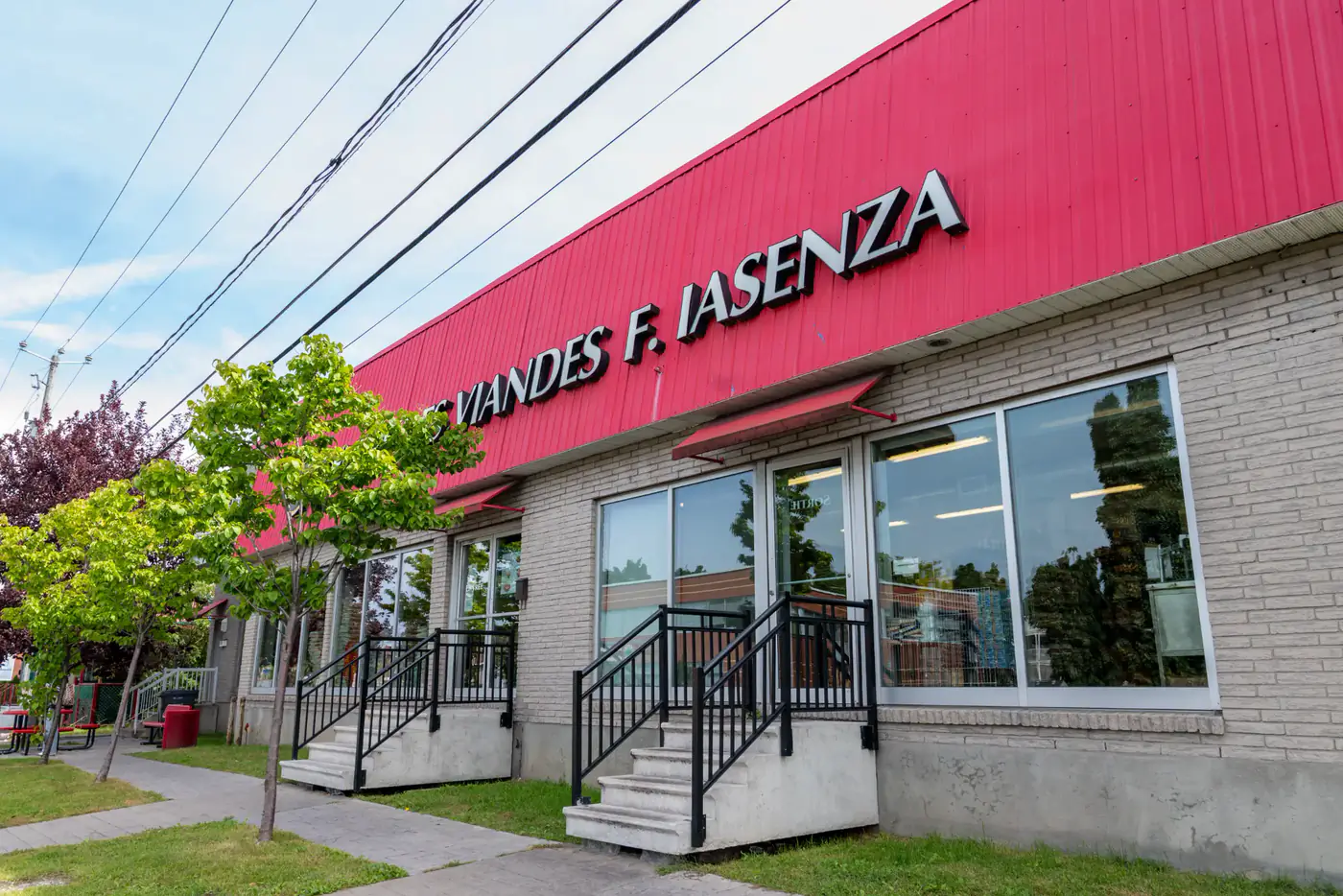 Brick storefront of the Longueuil store with the red Centre des Viandes F. Iasenza sign