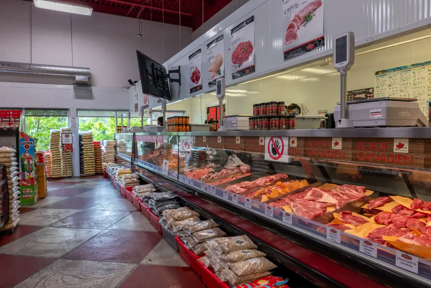 Refrigerated meat counter and checkered floor at the Longueuil store