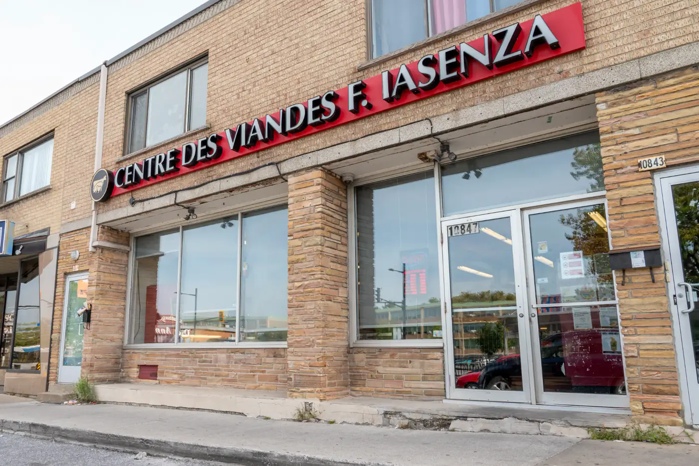 Brick storefront of the Montréal-Nord store with the red Centre des Viandes F. Iasenza sign