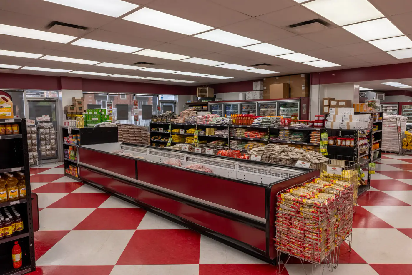 Grocery aisles and a central freezer case at the St-Michel store