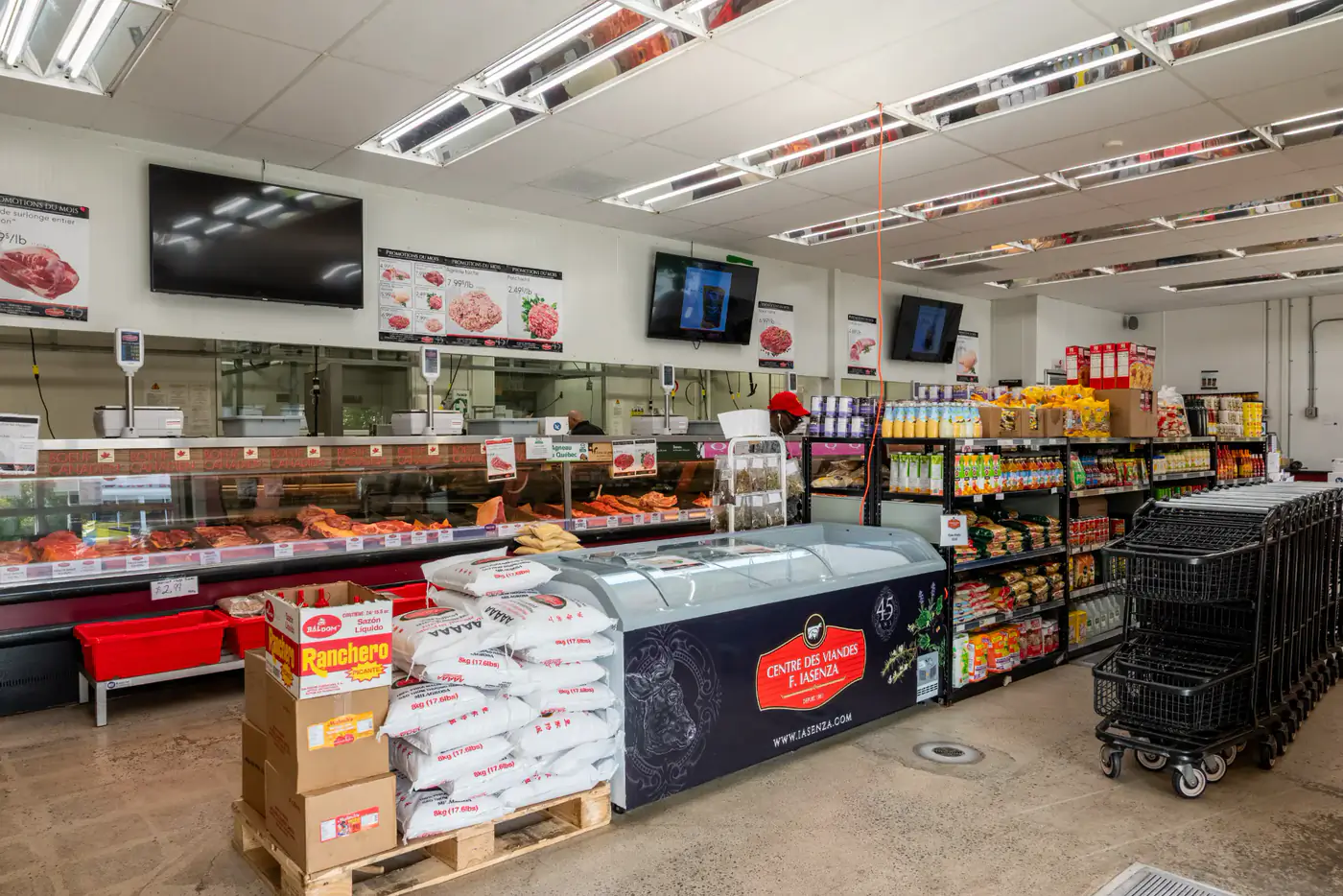 Inside the Tétreaultville store, with the meat counter, a freezer case and grocery shelves