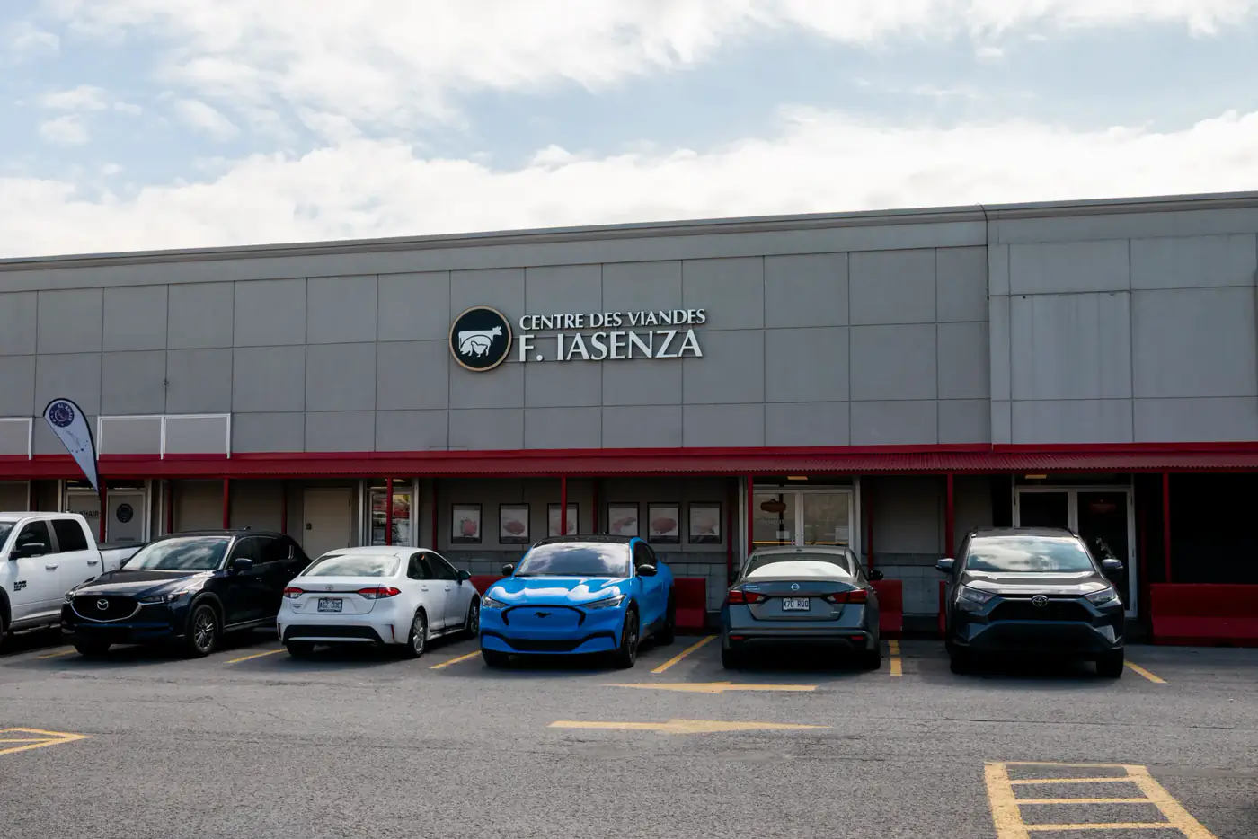 Grey storefront of the Vimont store with the Centre des Viandes F. Iasenza sign and parking lot
