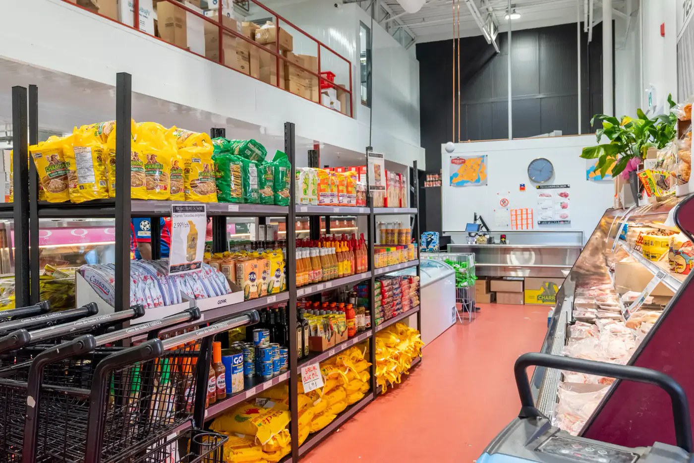 Grocery shelves and a refrigerated case at the Vimont store